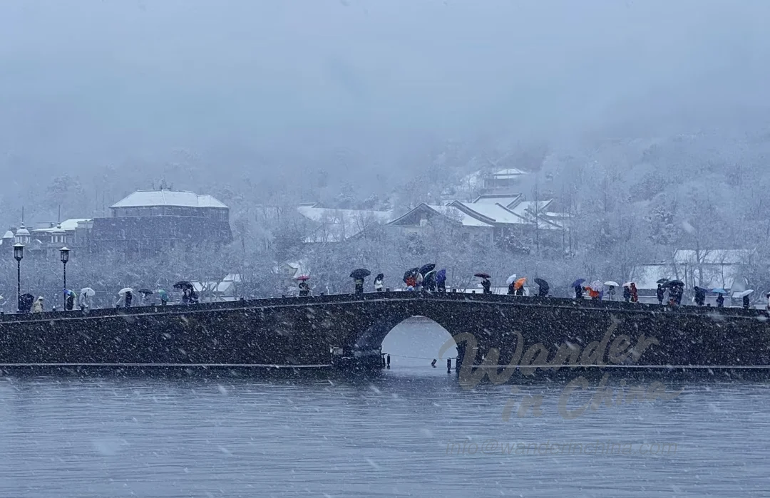 Broken Bridge West Lake in Winter Snow.
