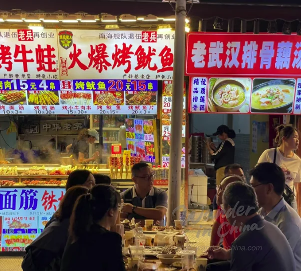 Bustling street food scene in Hubu Alley, Wuhan.
