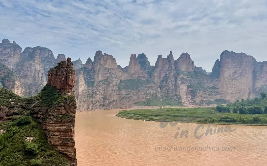 游船驶近黄河上的炳灵寺石窟。