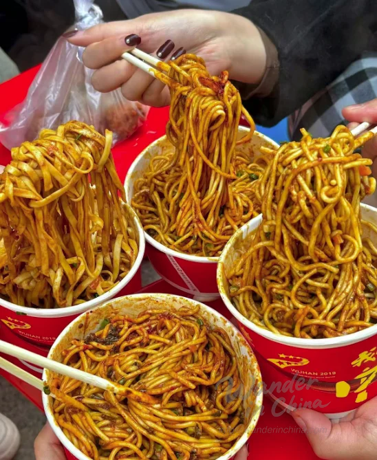 Tourist enjoying Re Gan Mian in Wuhan.
