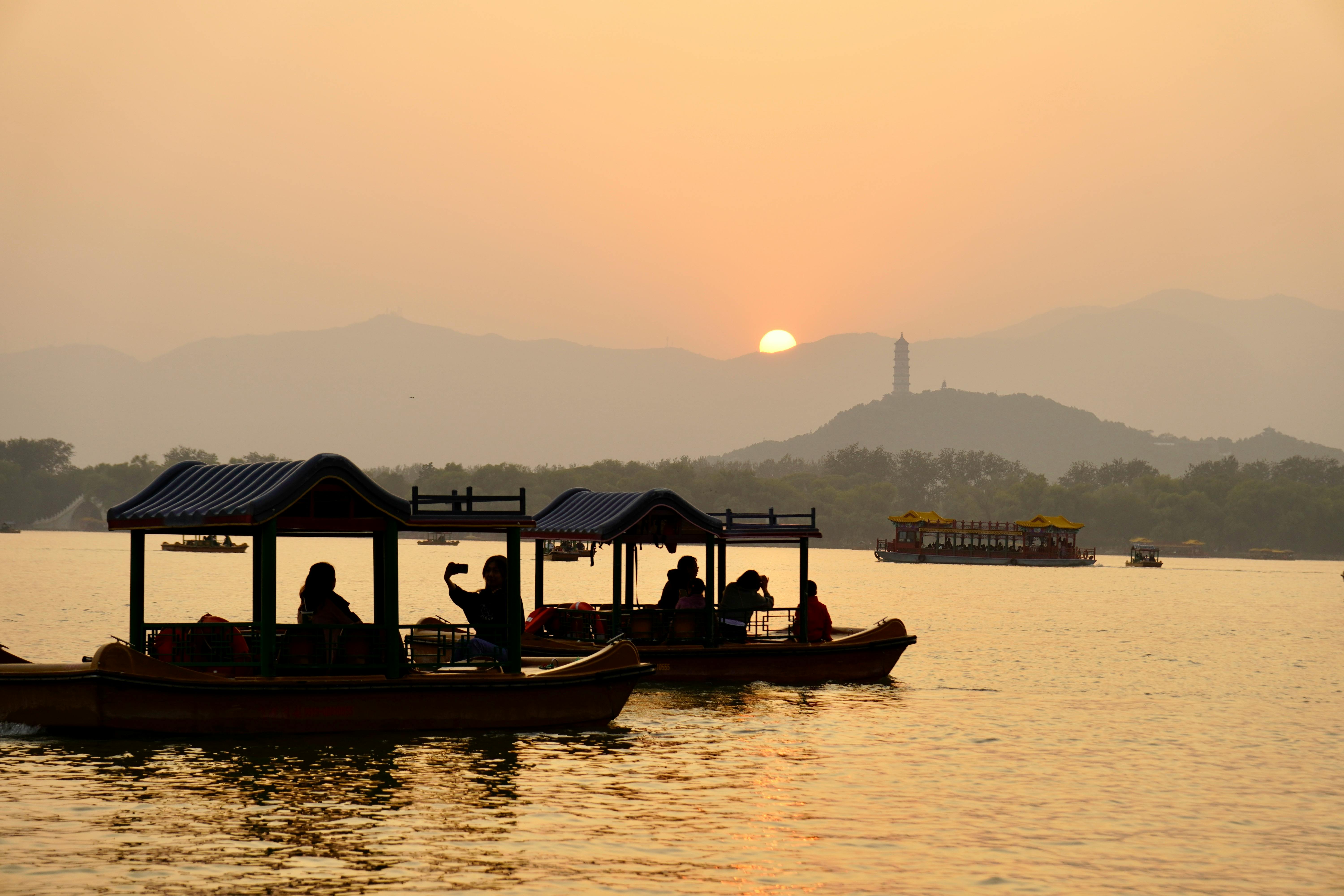 West Lake boat tour at sunset with Leifeng Pagoda.